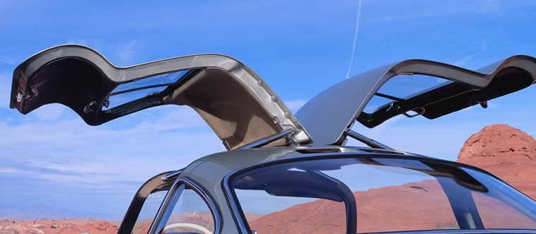 Lock in the clue: which legendary ride is famous for its distinctive, upward-swinging gull-wing doors?