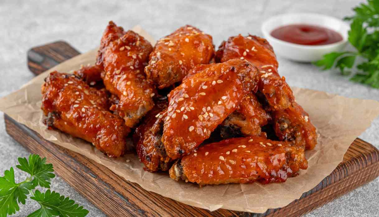 Lock in the clue: which upstate New York city turned deep-fried, hot-sauce-slathered wings into a global game-day legend?
