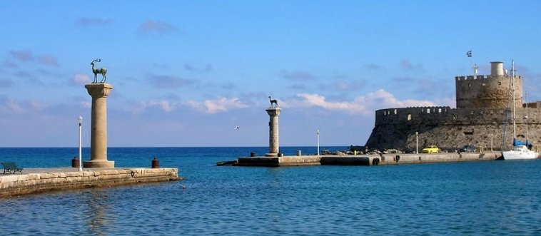 Lock in the clue: which legendary ancient wonder loomed large as a giant statue protecting a Greek harbor?