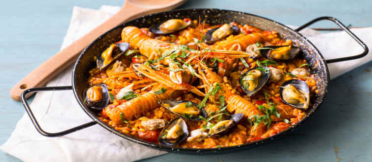 Blink and think: which country originally served up the vibrant, saffron-tinted rice masterpiece known as paella?