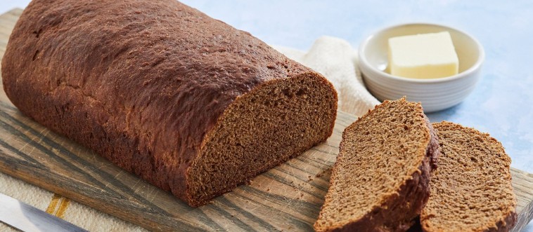 Can you name this loaf? Hint: it's rye’s moody, deeply flavorful relative that gives a classic Reuben its bold signature bite.