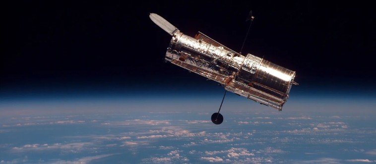 Blink and think — which year did the Hubble Space Telescope launch into orbit to forever change how we view the cosmos?