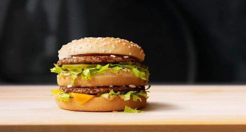 Lock in the clue: which fast-food powerhouse is legendary for serving up this massive, double-decker burger?